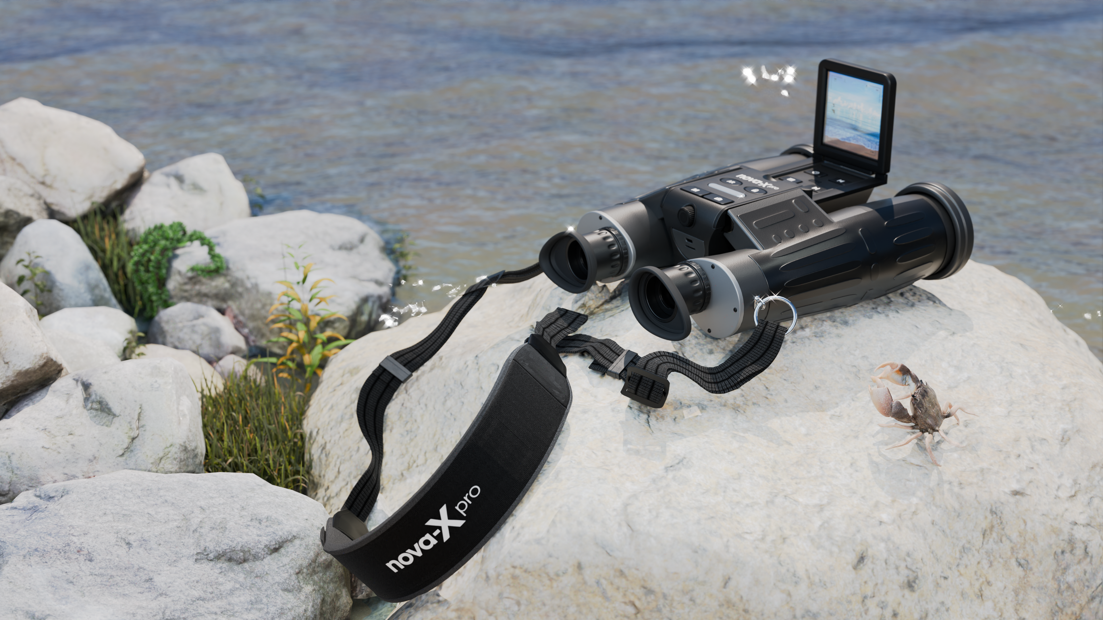 Black digital binoculars resting on shoreline rocks